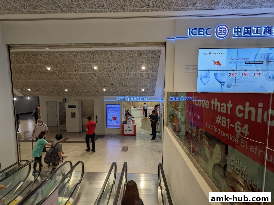 The entrance to ICBC Ang Mo Kio Sub-Branch with promotional displays and escalators.