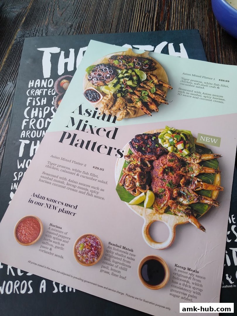 A close-up view of a menu featuring two Asian Mixed Platters with detailed descriptions and accompanying sauces.