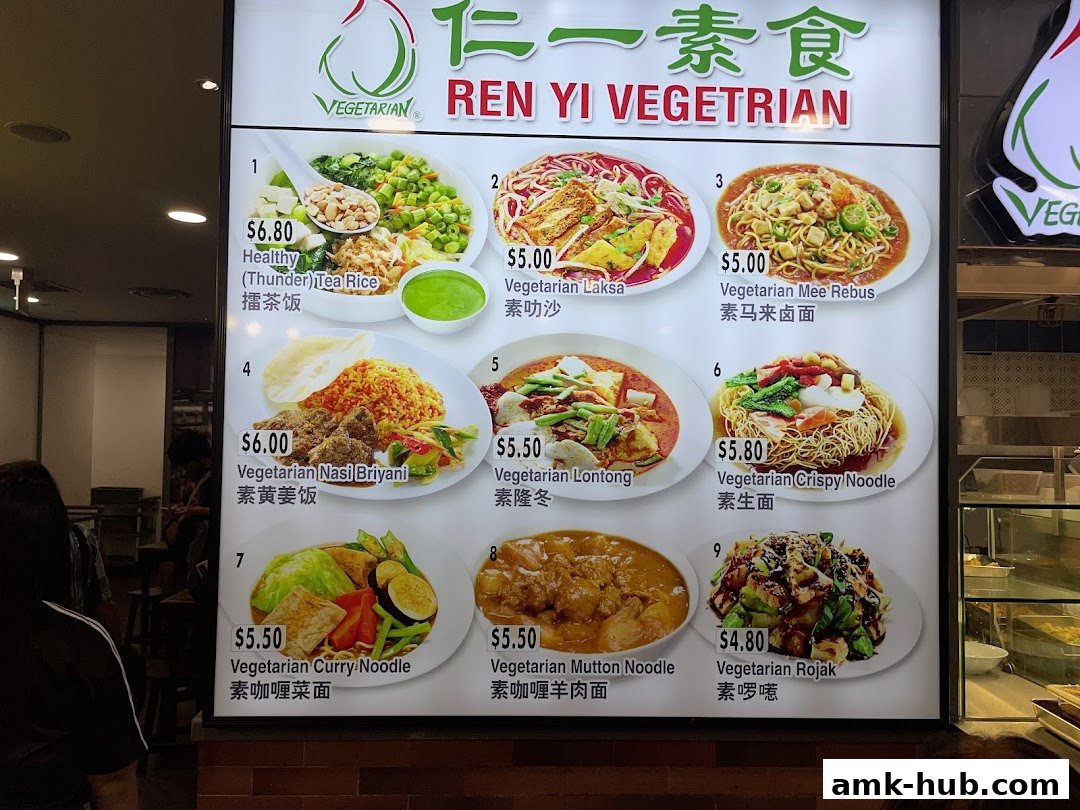 A brightly lit menu board displaying various vegetarian dishes with prices and images.