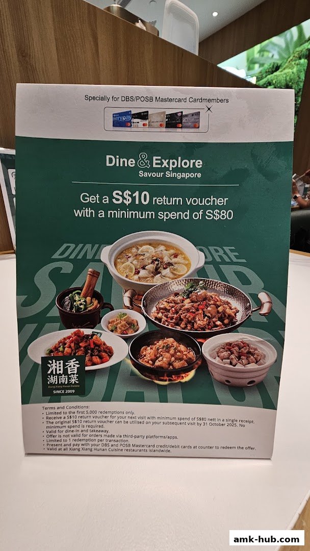 A promotional flyer for Xiang Xiang Hunan Cuisine offering a S$10 return voucher.