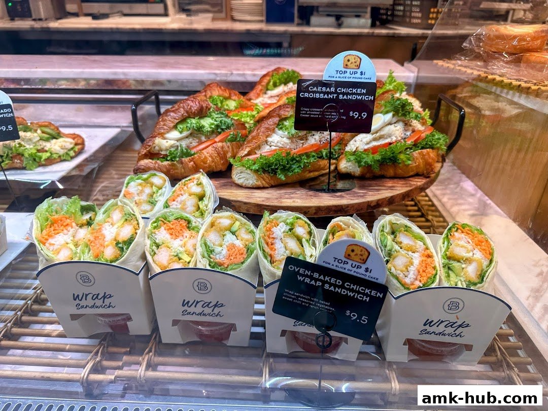A display of fresh croissant sandwiches and wrap sandwiches at Paris Baguette.