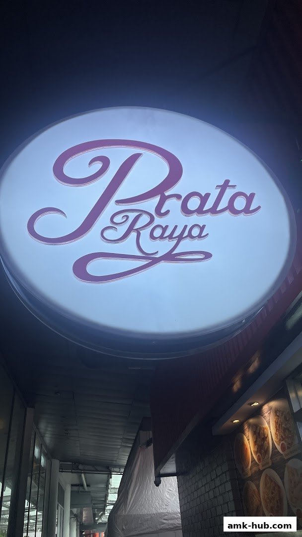 A brightly lit sign with the name 'Prata Raya' in elegant script.