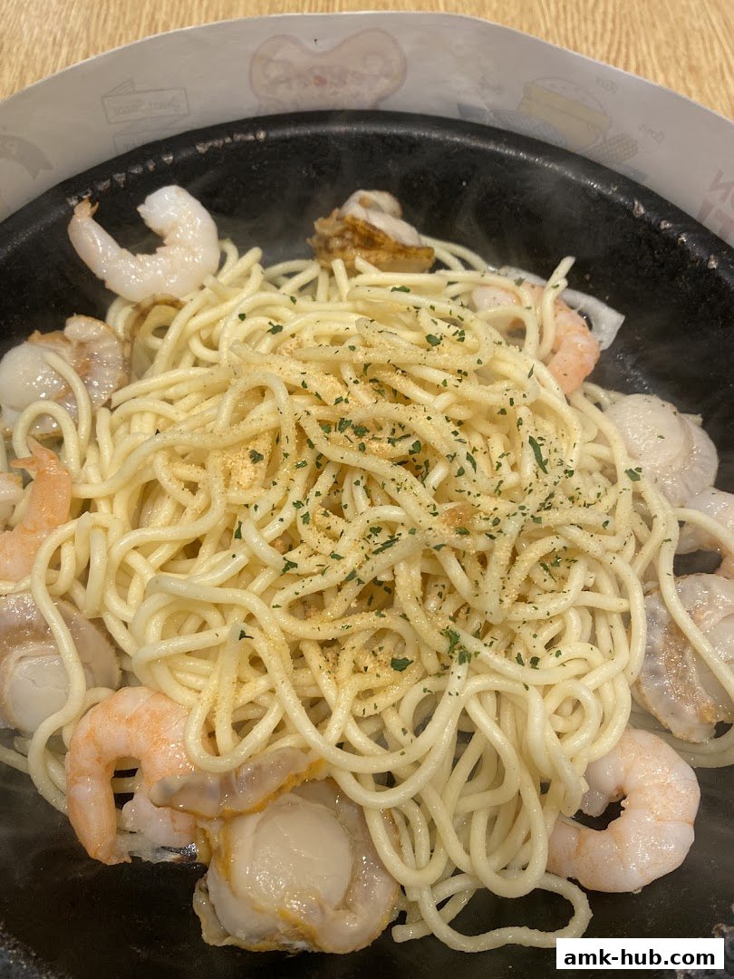 A close-up shot of a steaming hot seafood pasta dish with shrimp and scallops.