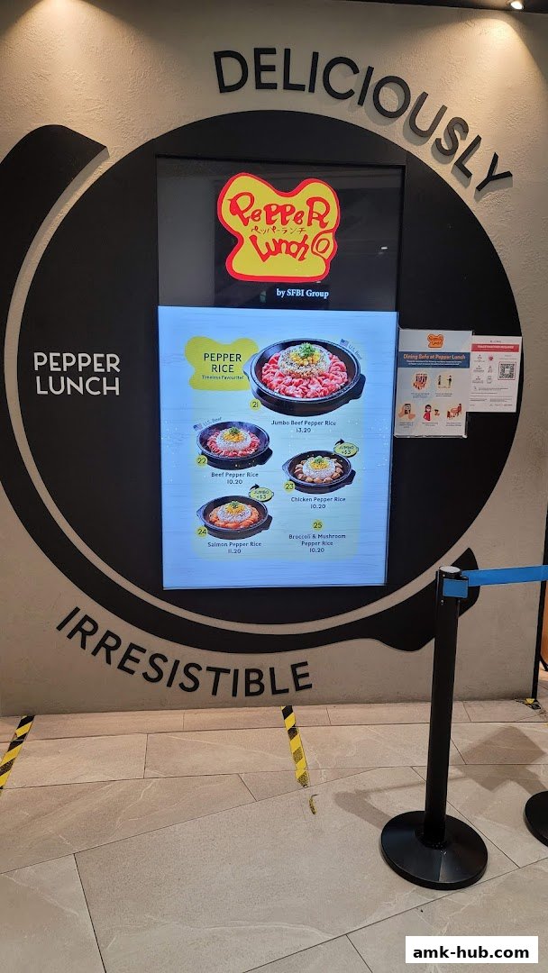 A digital menu board displaying various Pepper Rice dishes at Pepper Lunch.