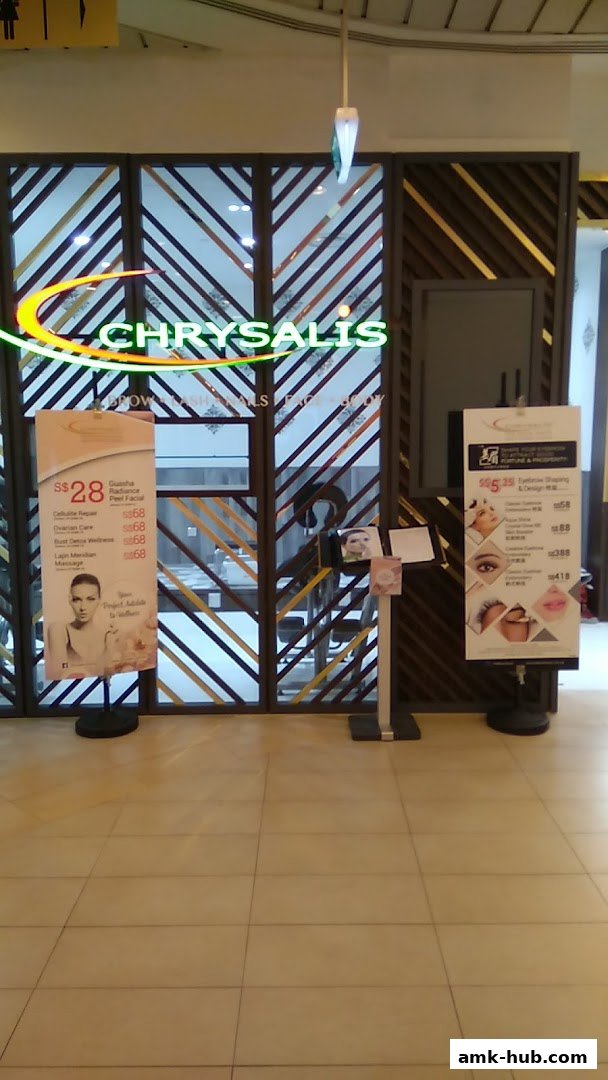 Chrysalis Spa shop front with promotional banners displaying services and prices.