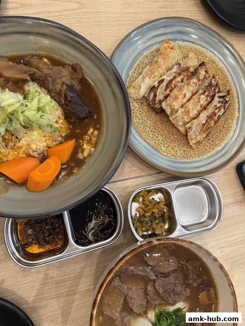 A close-up of several delicious dishes, including braised beef, rice, dumplings, and soup.