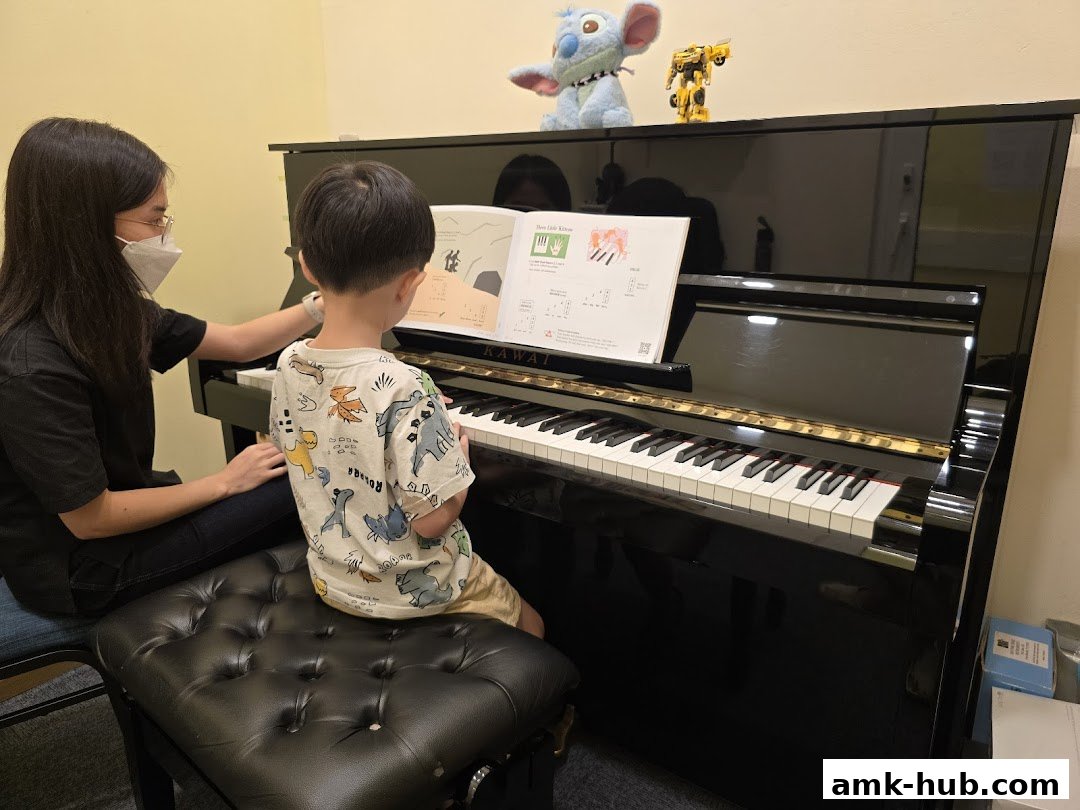 A piano teacher instructs a young student on a Kawai piano.