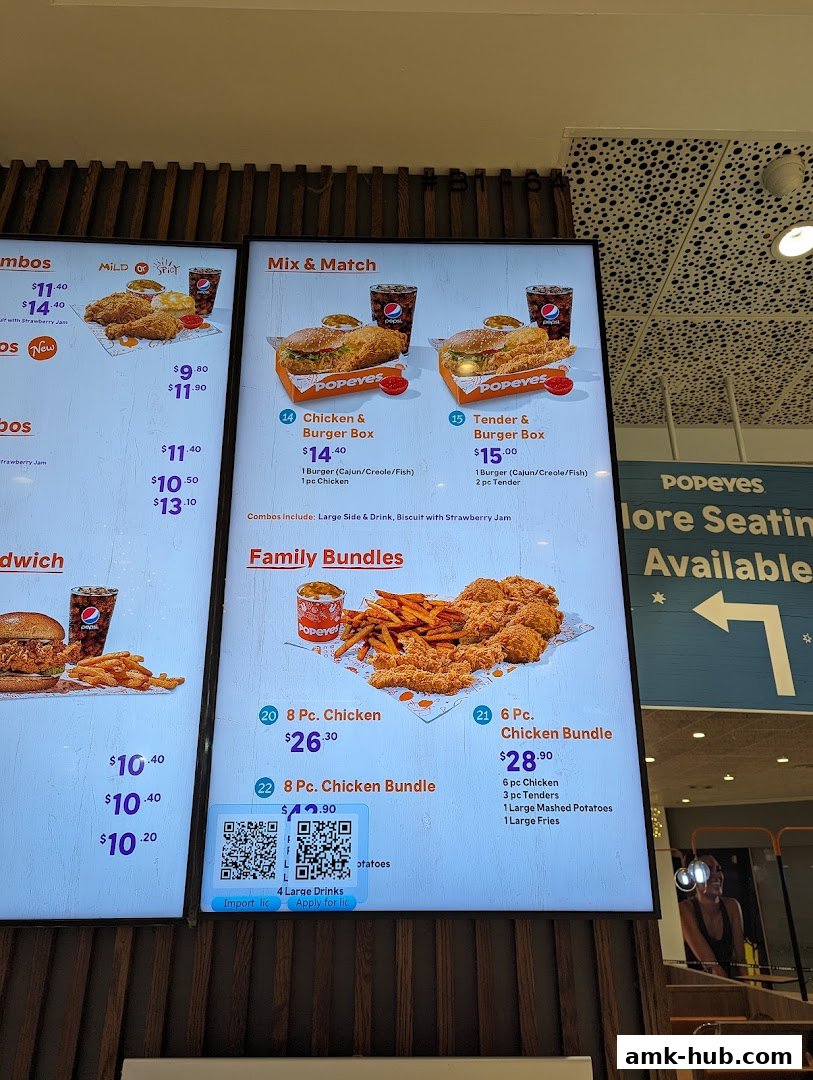 A digital menu board displaying Popeyes chicken combos, burgers, and family bundles.