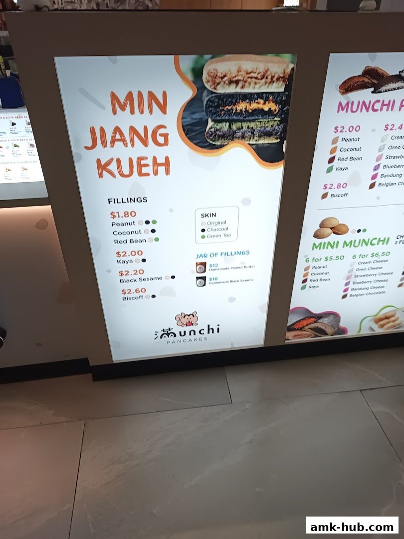 A brightly lit menu board displaying various Min Jiang Kueh fillings and options.