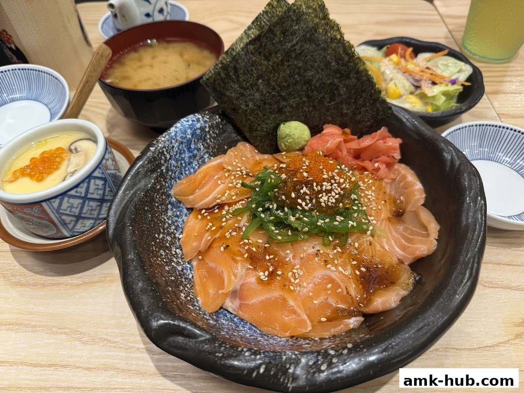 A delicious salmon kaisendon bowl with miso soup, chawanmushi, and salad.