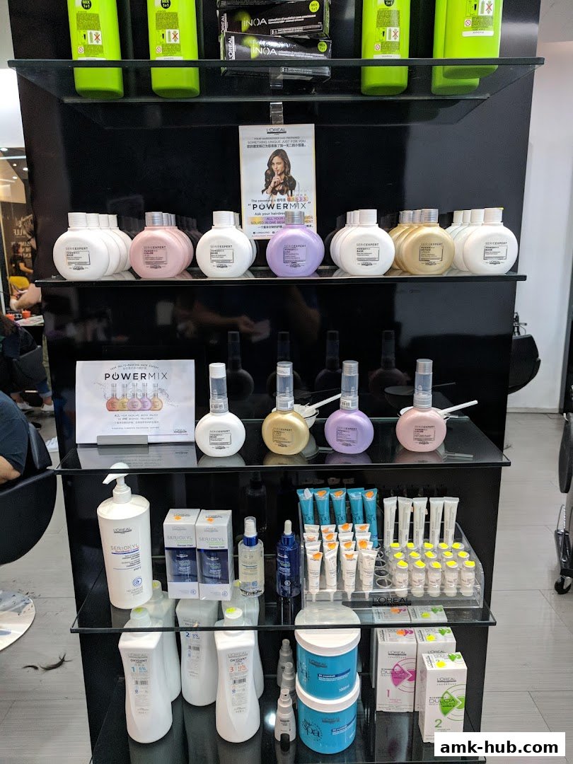 Shelves display various L'Oréal hair care products, including shampoos, conditioners, and treatments.
