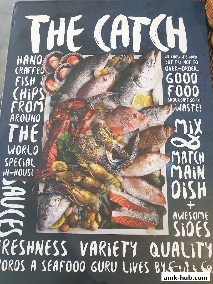 A vibrant display of fresh seafood, including fish, lobster, and shellfish, on ice.