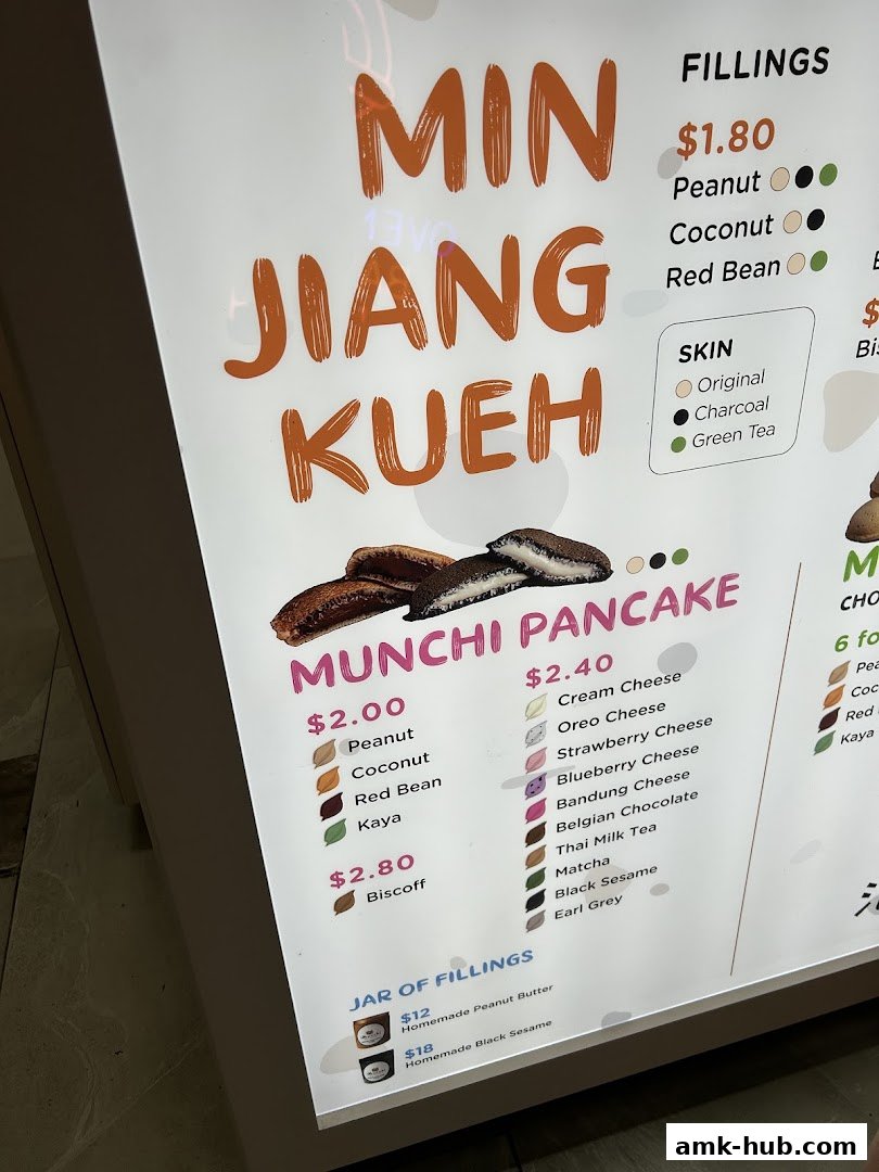 A menu board for Munchi Pancakes, showcasing various fillings and skin options.