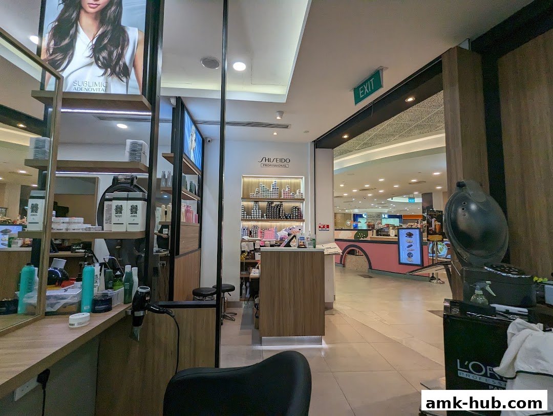 Interior view of a hair salon with styling stations and product displays.