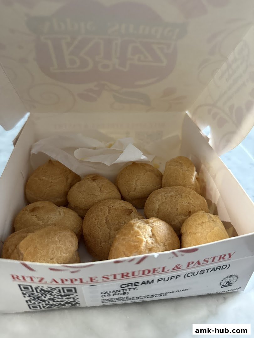 A box of freshly baked cream puffs from Ritz Apple Strudel & Pastry.