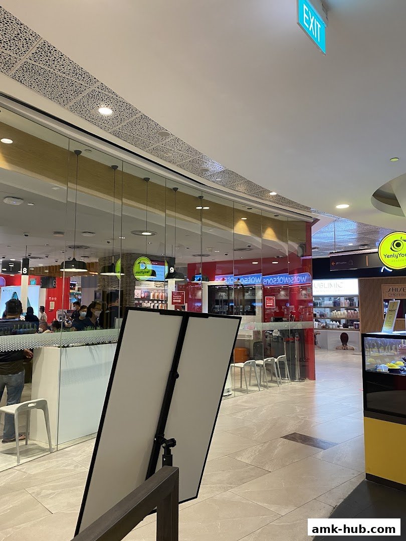The exterior of a Singtel shop with customers inside and displays visible through the glass.
