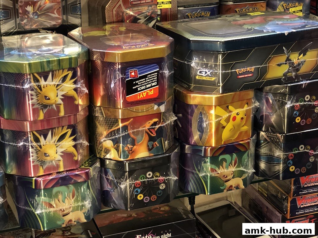 A display of various Pokémon trading card game tins featuring popular characters like Pikachu and Charizard.