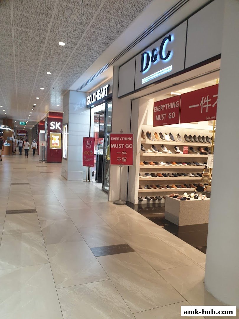 The D&C shoe store entrance with shoes displayed and sale signs.