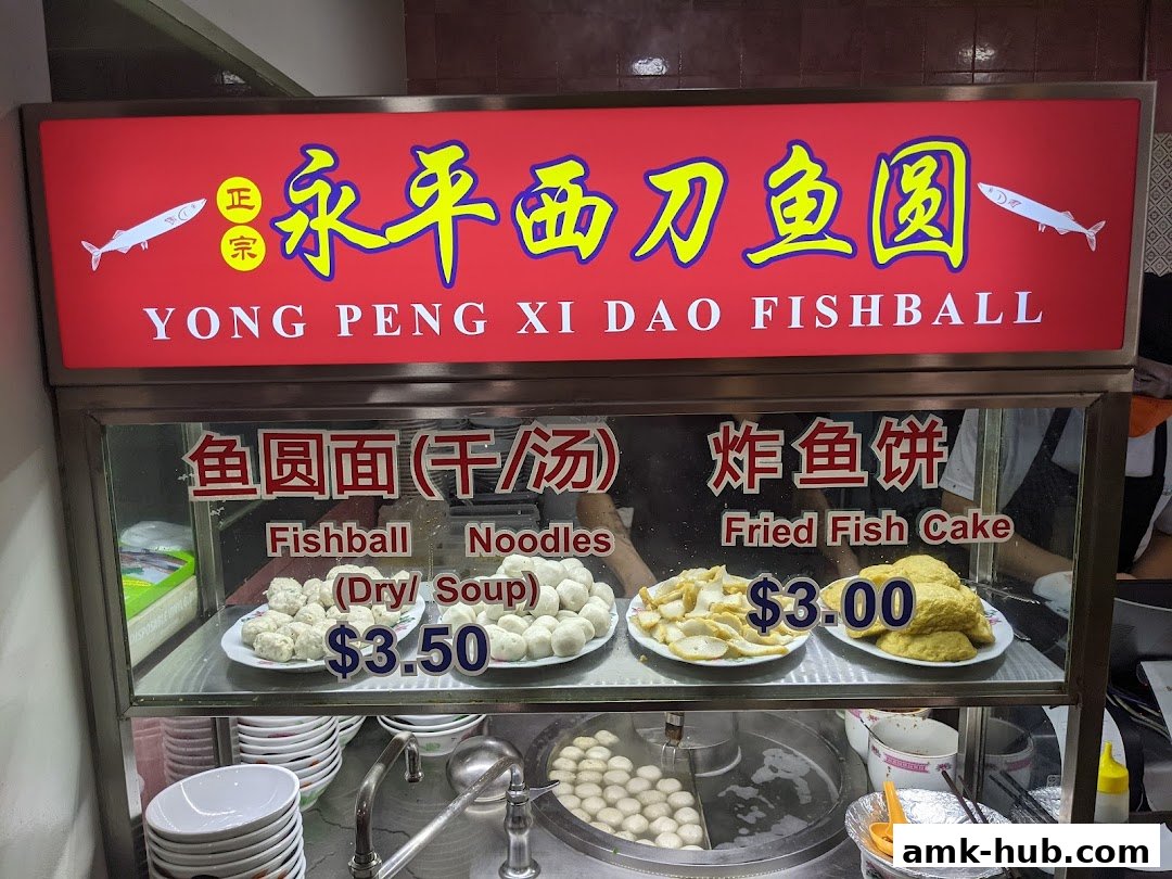 A display of Yong Peng Xi Dao Fishball with prices for fishball noodles and fried fish cake.