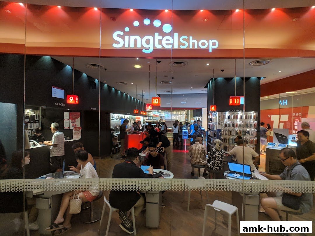 Interior view of a busy Singtel shop with customers and staff interacting.
