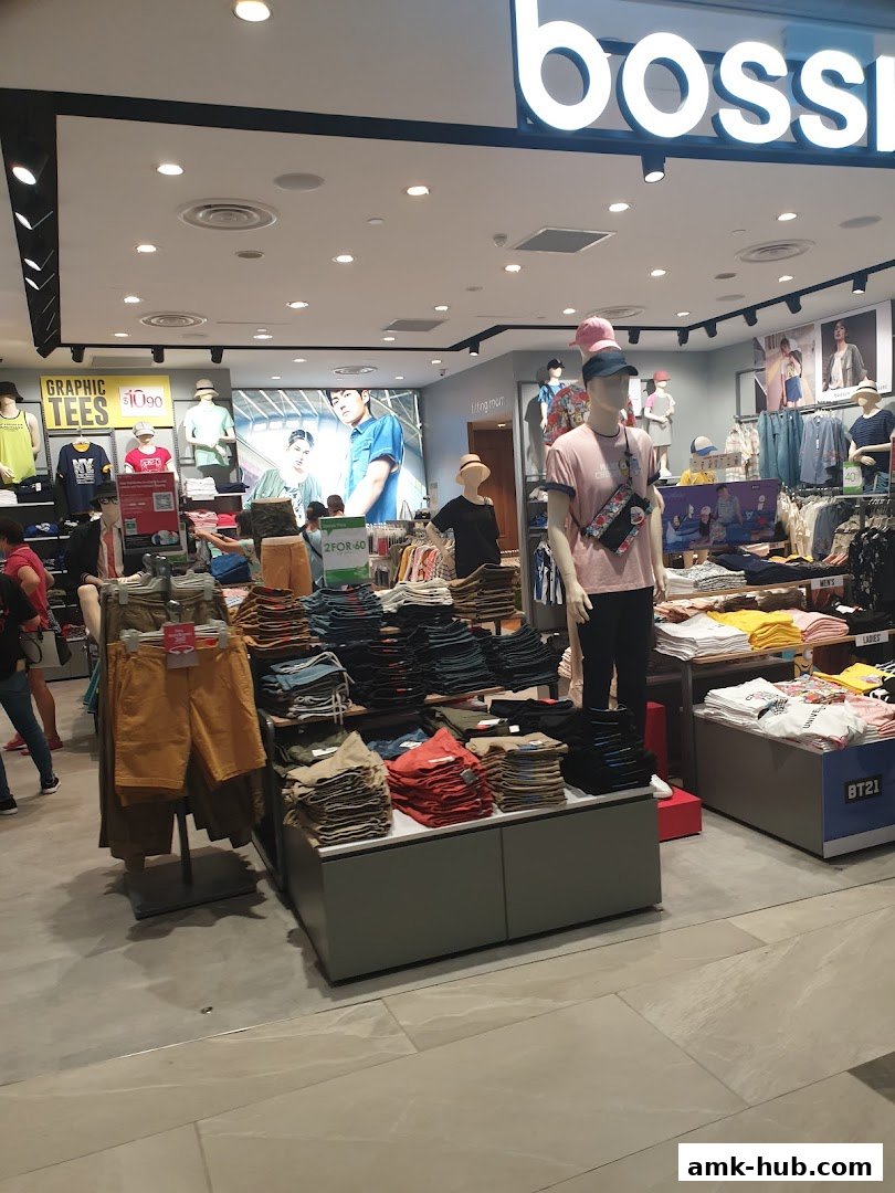Interior view of a Bossini clothing store showcasing folded apparel and mannequins.