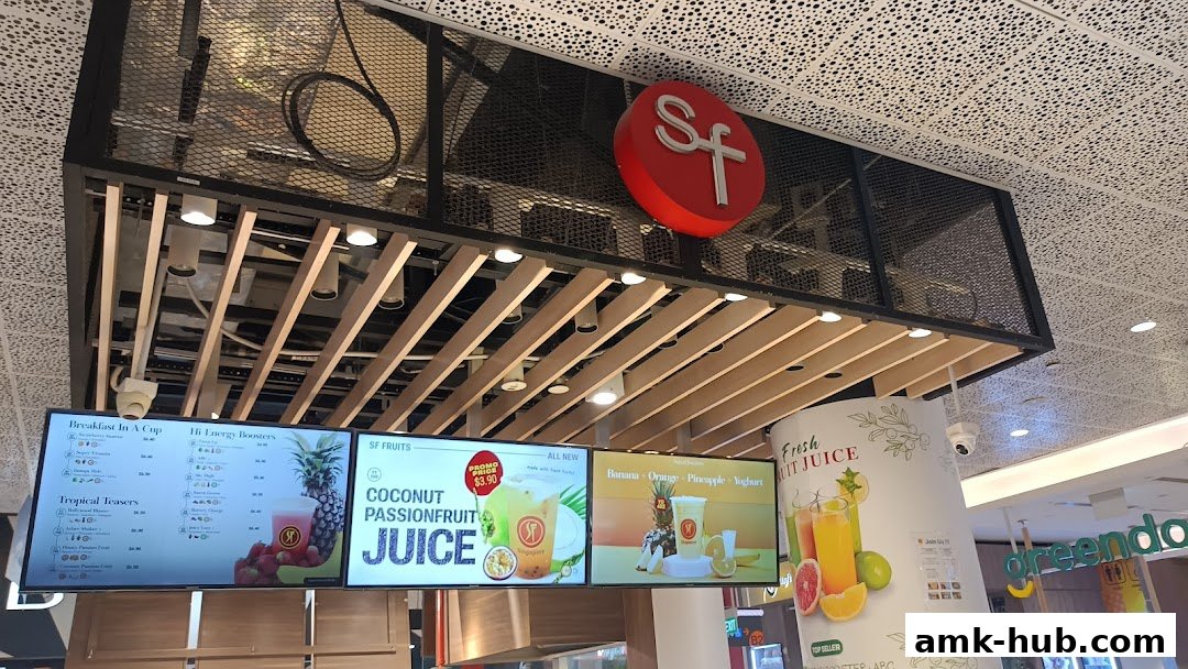 Digital menu boards displaying various fruit juices and breakfast options at SF Fruits Juices.