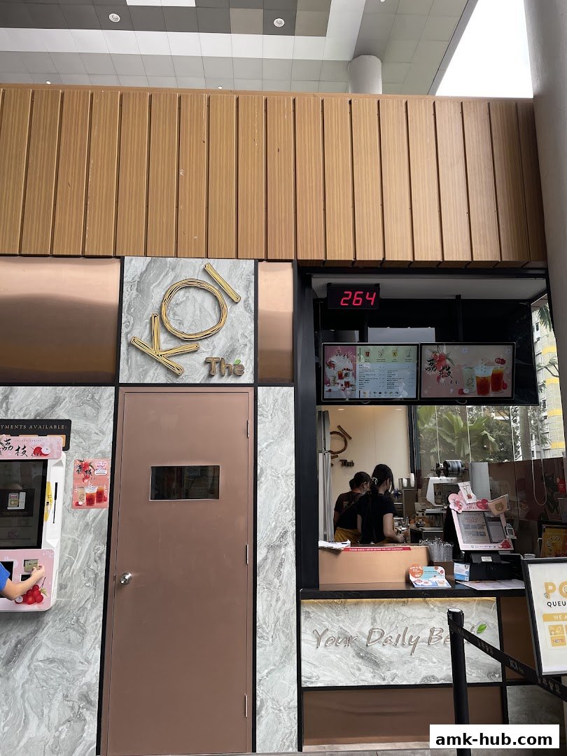 The KOI Thé shop front with a door, ordering counter, and menu displays.
