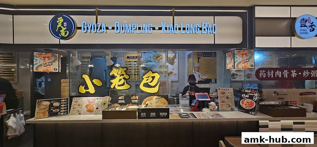 A food stall specializing in Gyoza, Dumplings, and Xiao Long Bao with a vibrant display.
