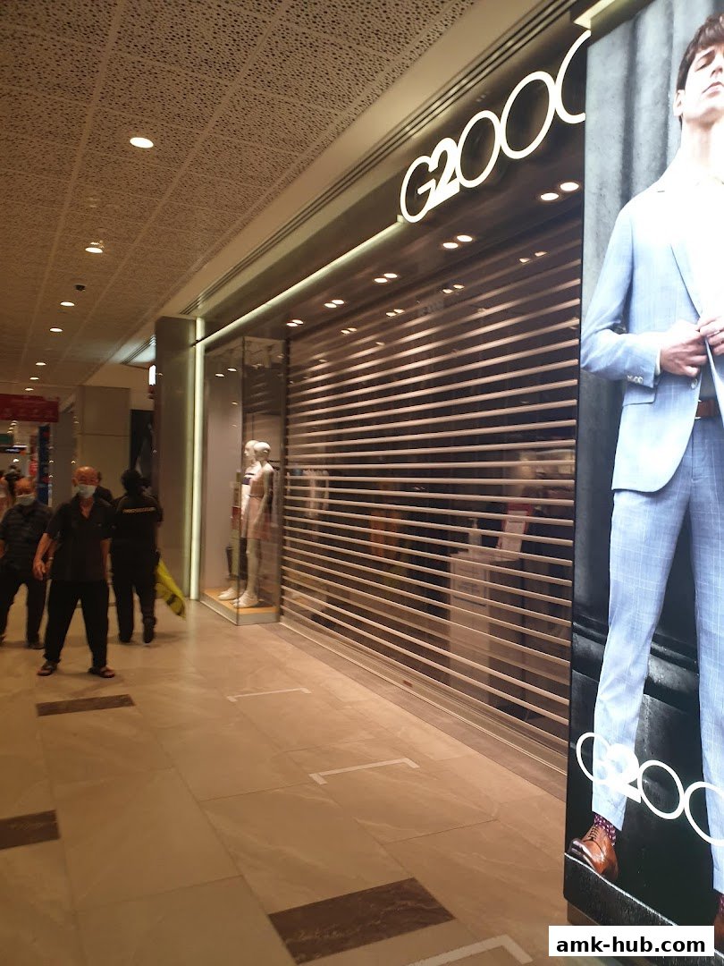 The G2000 shop front with a large advertisement of a man in a suit.