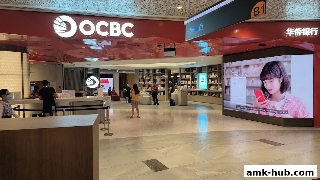 The entrance of OCBC Bank with a digital display showing identity verification.
