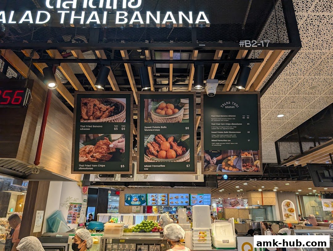 A menu board for Talad Thai Banana, showcasing fried banana, yam chips, and sweet potato balls.