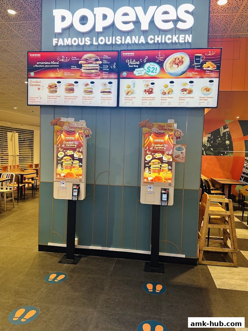 Popeyes Famous Louisiana Chicken restaurant with digital menu boards and ordering kiosks.