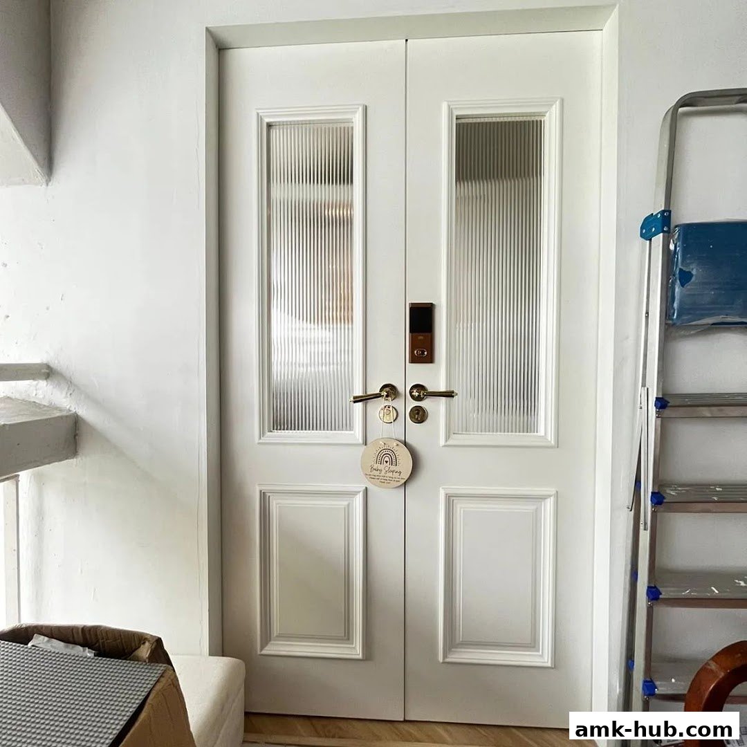 A white double door with glass panels, a digital lock, and a decorative tag.