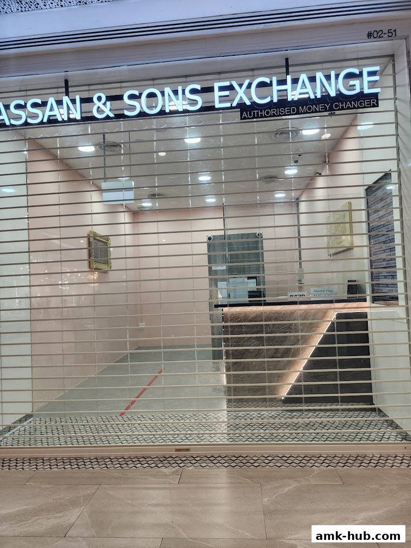 Hassan & Sons Exchange, an authorized money changer, with its storefront secured by a rolling shutter.