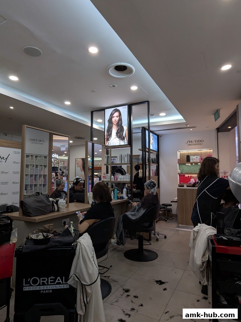 Interior of a hair salon with clients receiving services and stylists working.