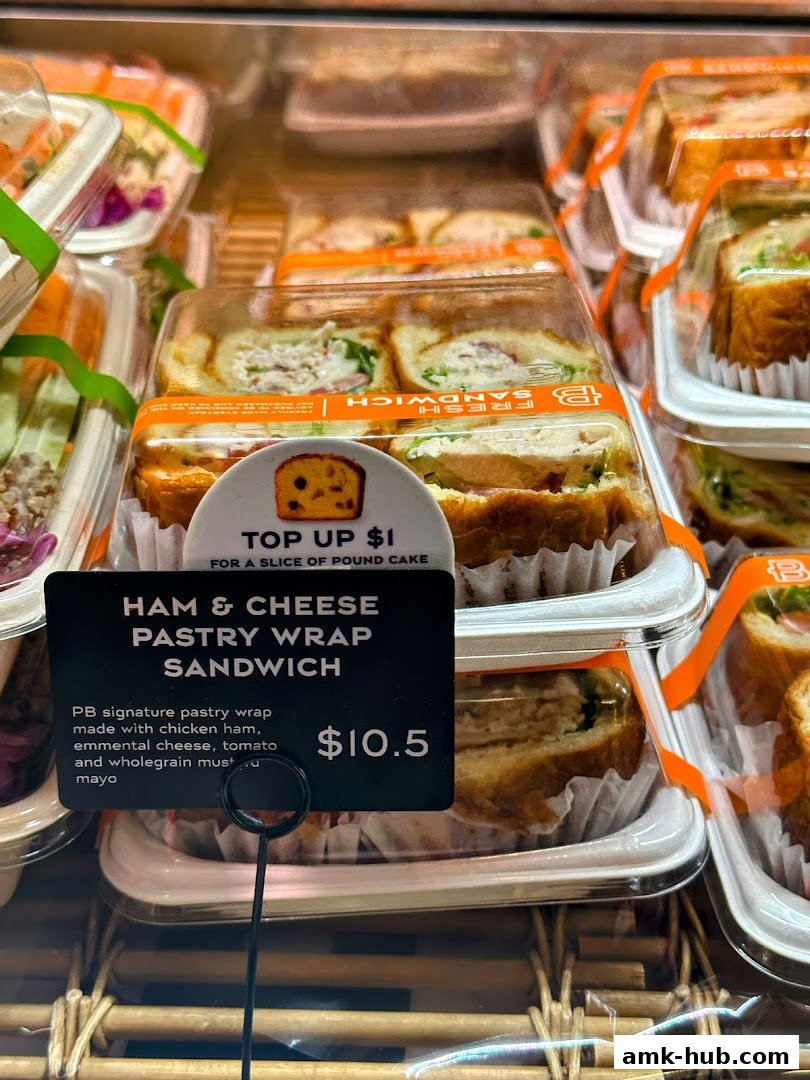 A close-up of a Ham & Cheese Pastry Wrap Sandwich with a price tag.