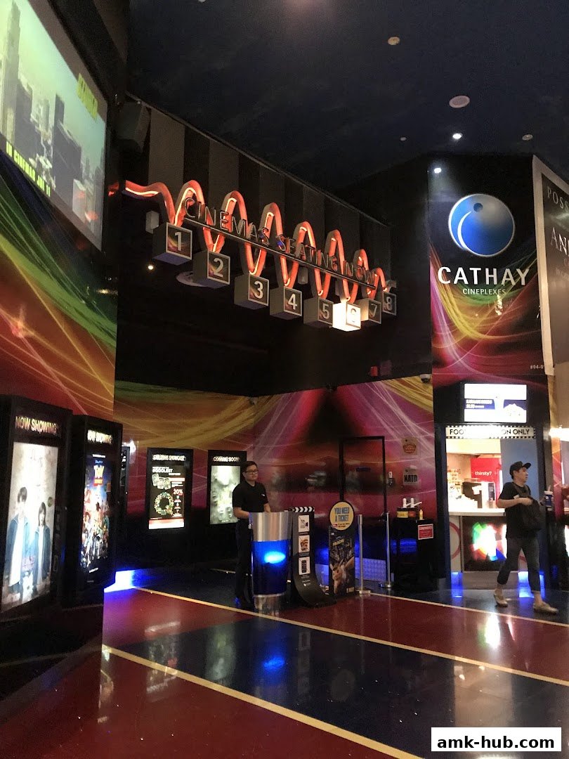 Interior view of Cathay Cineplexes with movie posters, seating indicators, and staff.