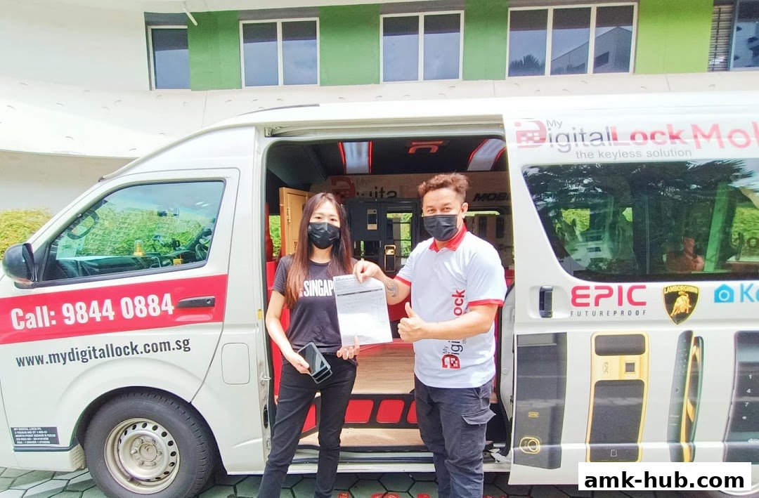 Two people stand in front of a van displaying digital locks and contact information.