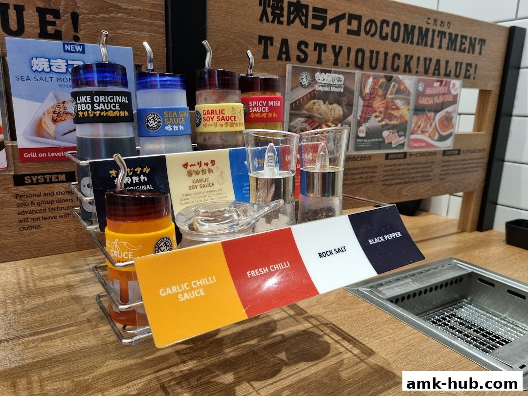 Condiments and sauces displayed at a Yakiniku Like restaurant, including various sauces and seasonings.
