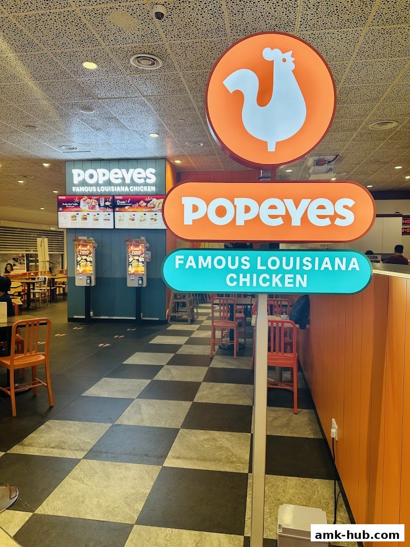 Popeyes Famous Louisiana Chicken restaurant interior with signage and seating.