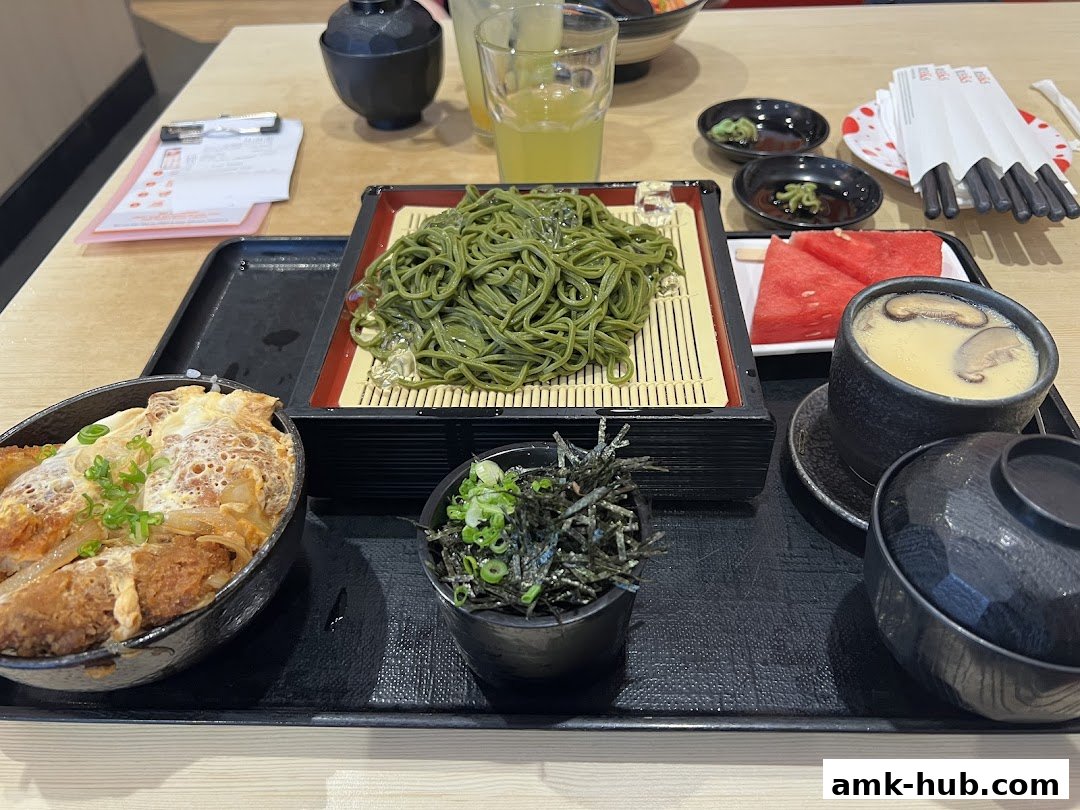 A delicious Japanese meal featuring soba noodles, katsudon, chawanmushi, and watermelon.