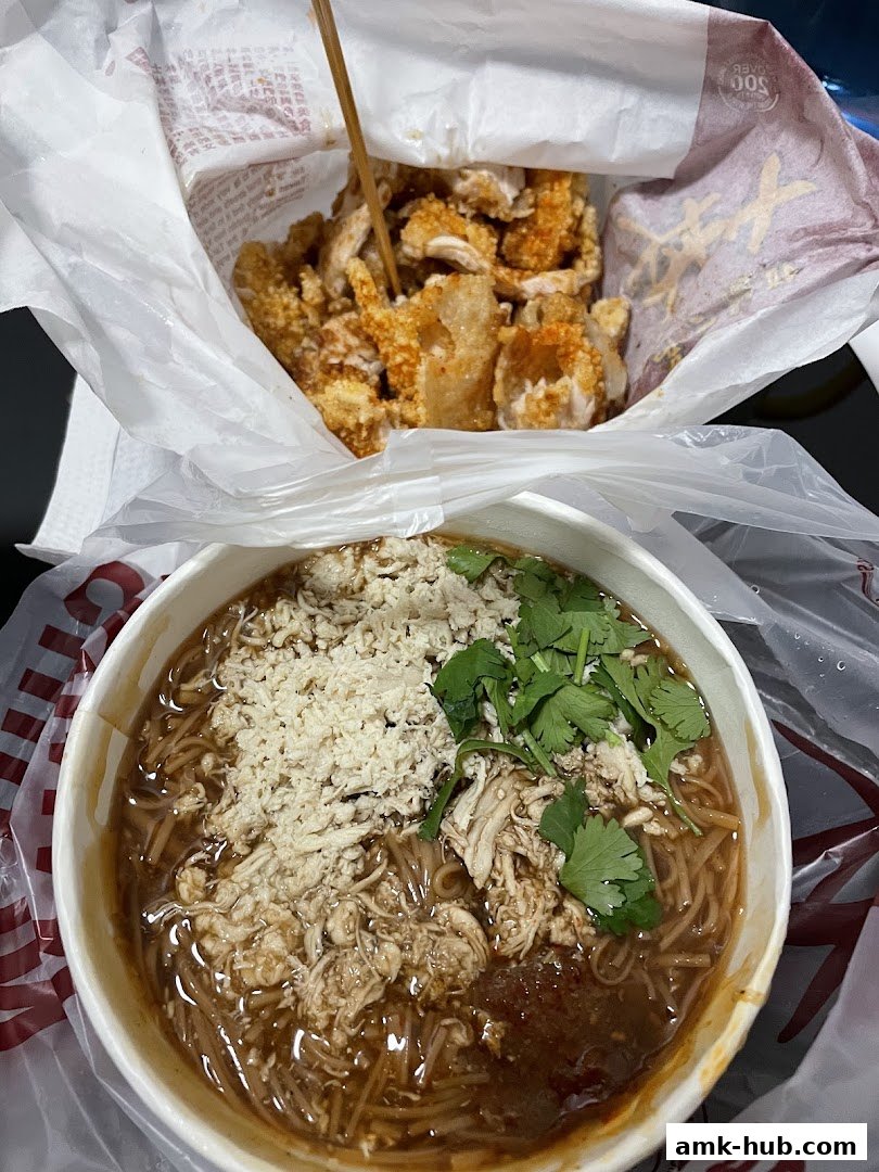 A bowl of Taiwanese oyster omelet and a bag of fried chicken.