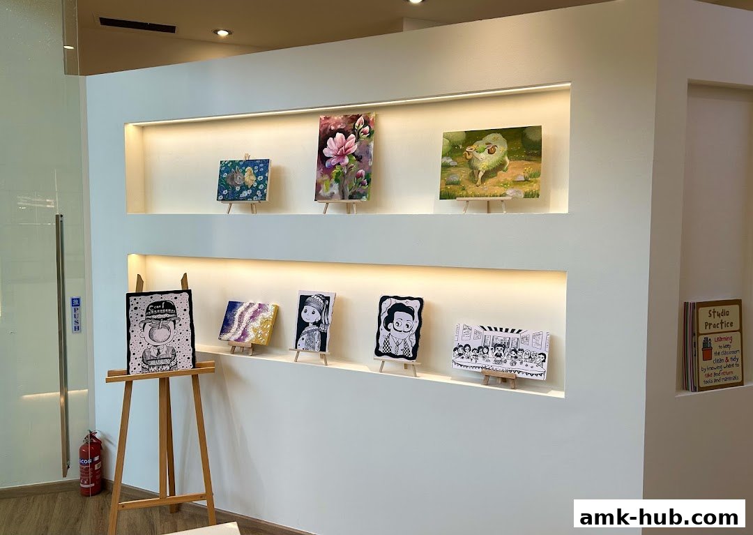 Artworks displayed on shelves in a bright, modern studio space.