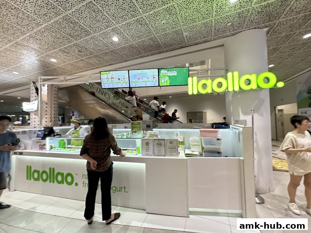 A brightly lit llaollao shop with customers ordering frozen yogurt.