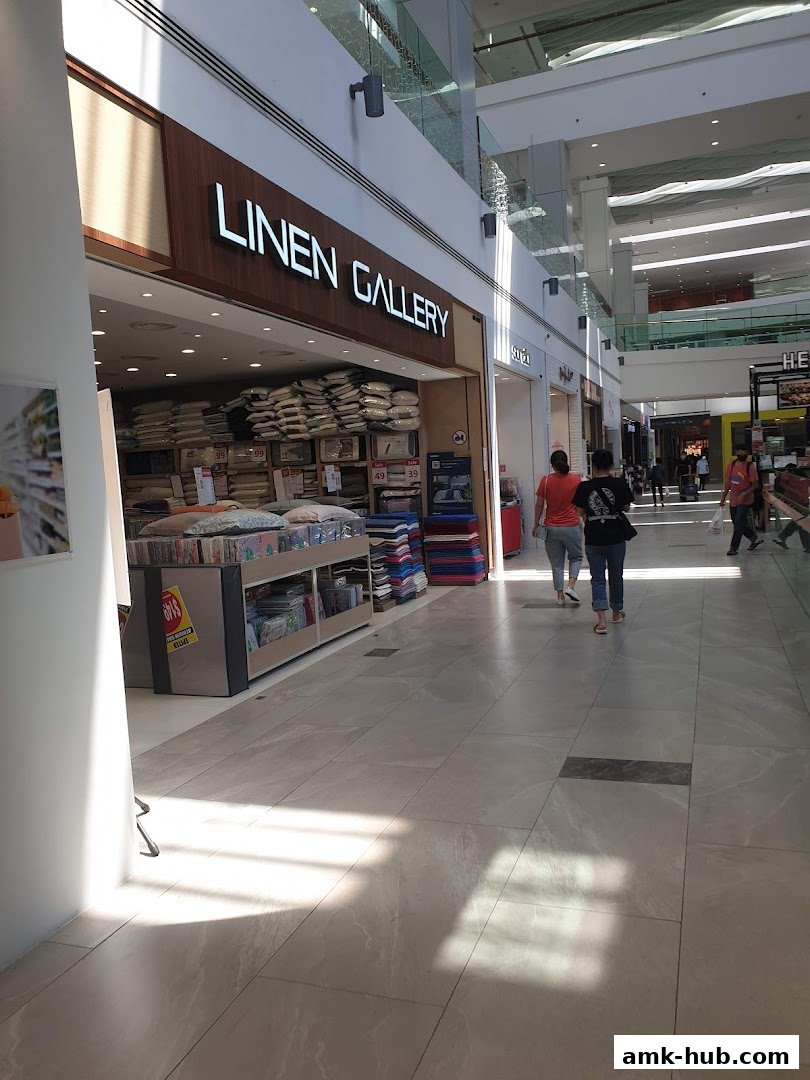 The exterior of the Linen Gallery shop in a mall, showcasing bedding and home goods.