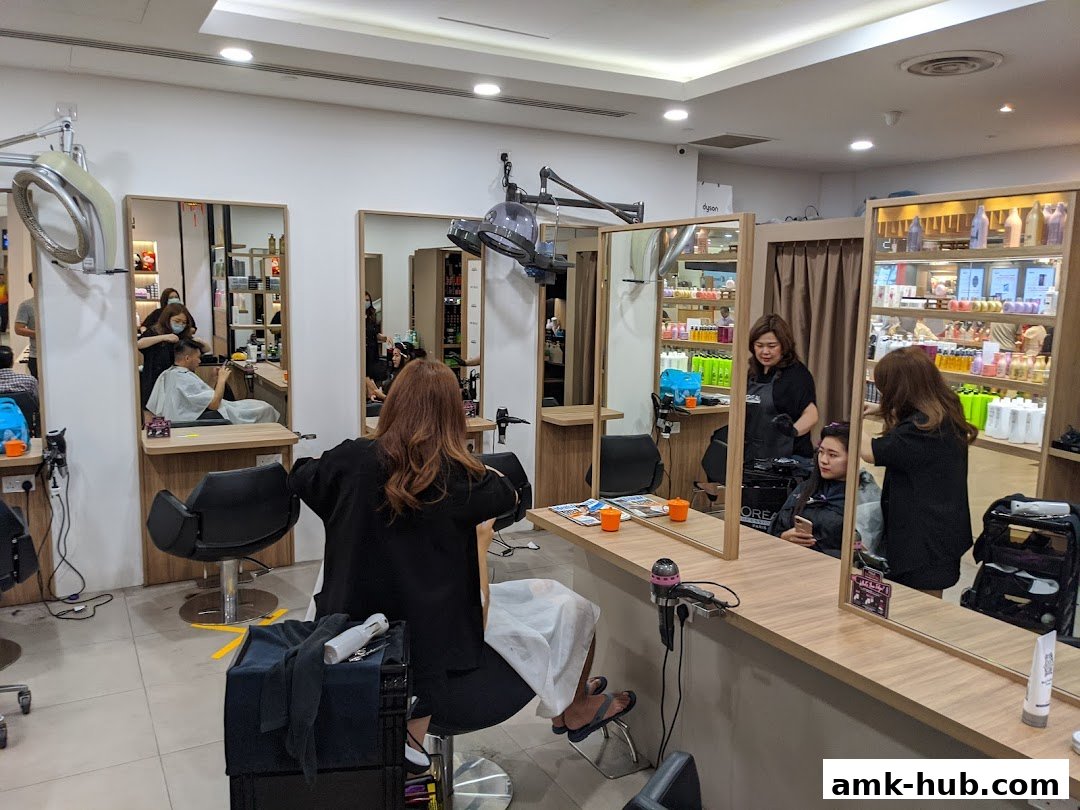 Hair salon interior with stylists attending to clients and shelves stocked with hair products.