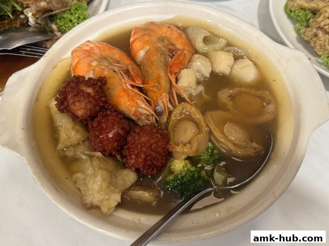 A close-up shot of a delicious seafood stew with prawns, abalone, scallops, and other ingredients.