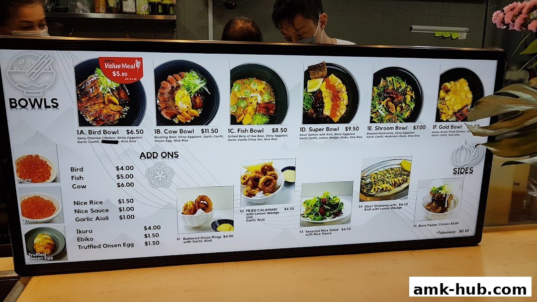 A digital menu board displaying various bowls, sides, and add-ons with images and prices.