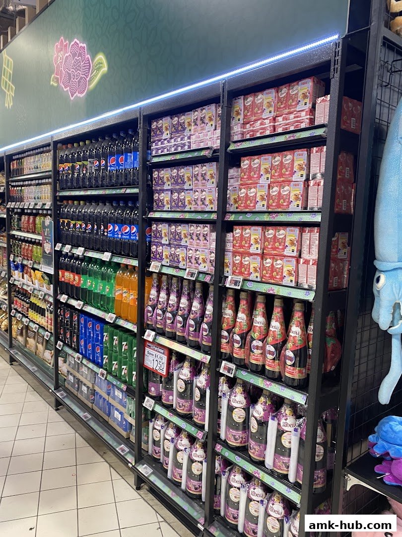 Shelves stocked with various beverages including sodas, juices, and other packaged drinks.