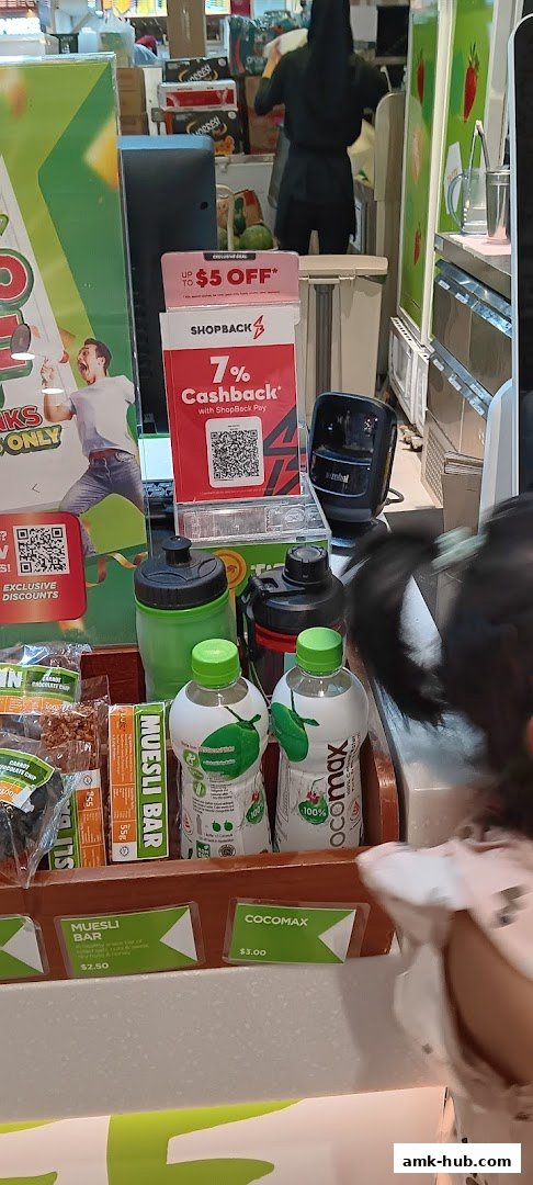 Boost Juice counter with drinks, snacks, and promotional displays.